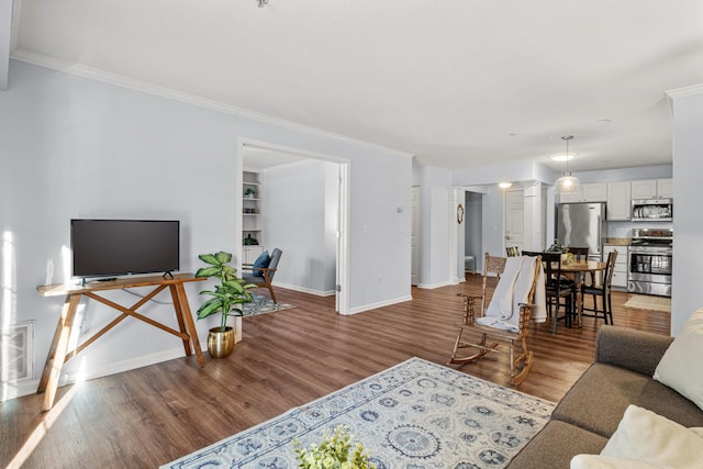 living room with ornamental molding, visible vents, baseboards, and wood finished floors