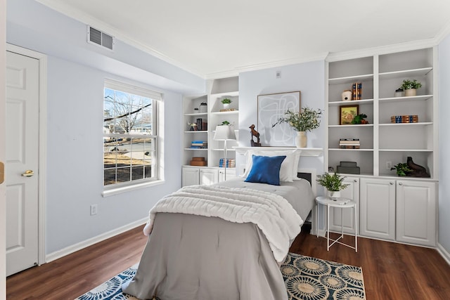 bedroom featuring baseboards, visible vents, dark wood finished floors, and ornamental molding