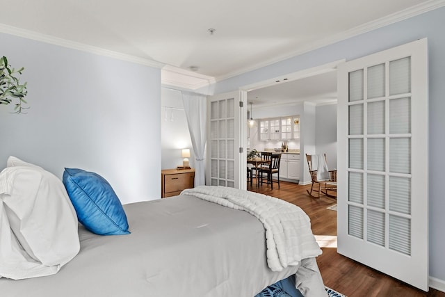 bedroom with dark wood finished floors and crown molding