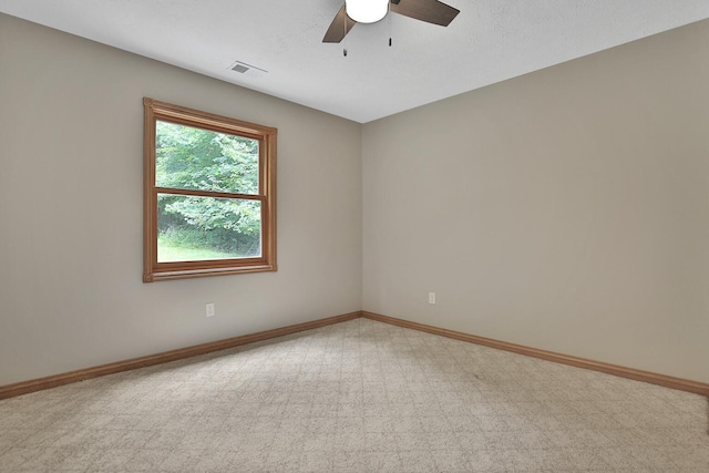 unfurnished room featuring light carpet and ceiling fan