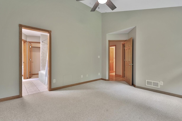 unfurnished bedroom with ceiling fan, light carpet, and connected bathroom