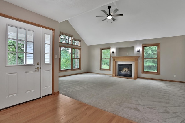 interior space featuring light wood-type flooring, plenty of natural light, ceiling fan, and vaulted ceiling