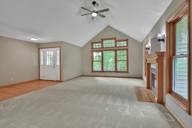 unfurnished living room with light carpet and ceiling fan