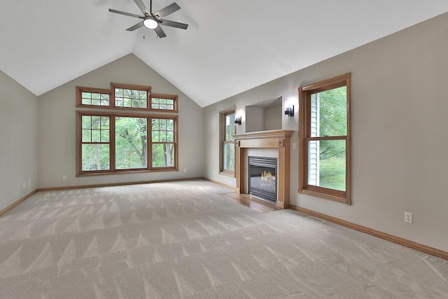 unfurnished living room with ceiling fan, light colored carpet, and lofted ceiling