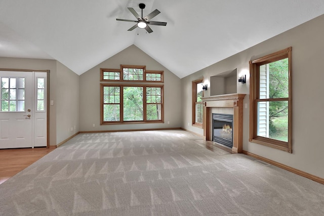 unfurnished living room with ceiling fan, light carpet, and vaulted ceiling