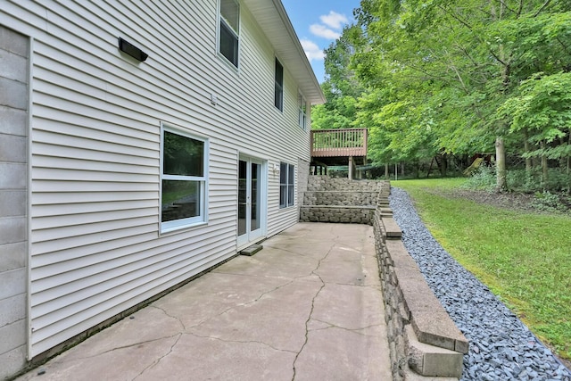 view of home's exterior with a yard and a patio