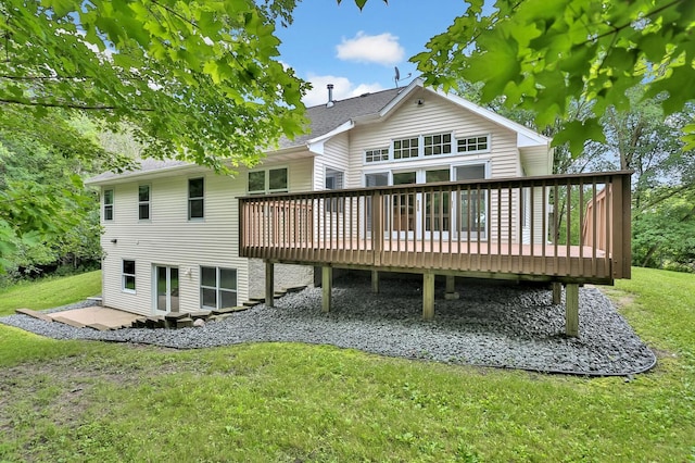 rear view of property featuring a lawn and a wooden deck