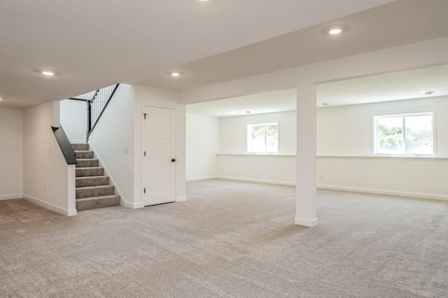 basement featuring light carpet and a healthy amount of sunlight