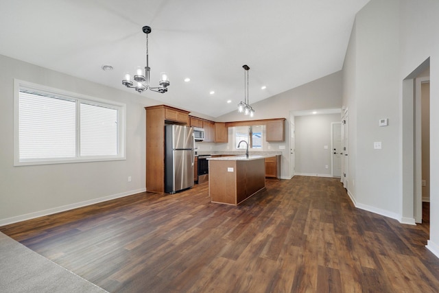 kitchen with a chandelier, hanging light fixtures, dark hardwood / wood-style floors, a kitchen island, and stainless steel appliances