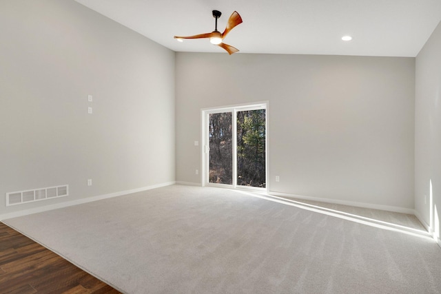 spare room featuring vaulted ceiling, dark hardwood / wood-style floors, and ceiling fan