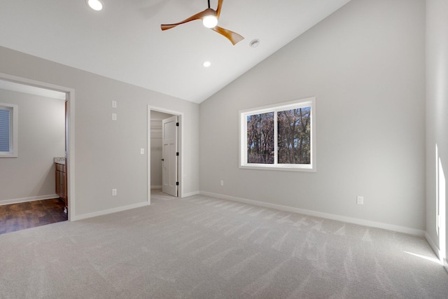 unfurnished bedroom with lofted ceiling, a walk in closet, ceiling fan, and carpet flooring