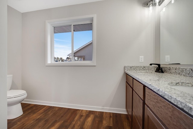 bathroom with vanity, hardwood / wood-style flooring, and toilet