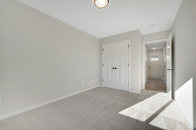 bedroom featuring light carpet and a closet