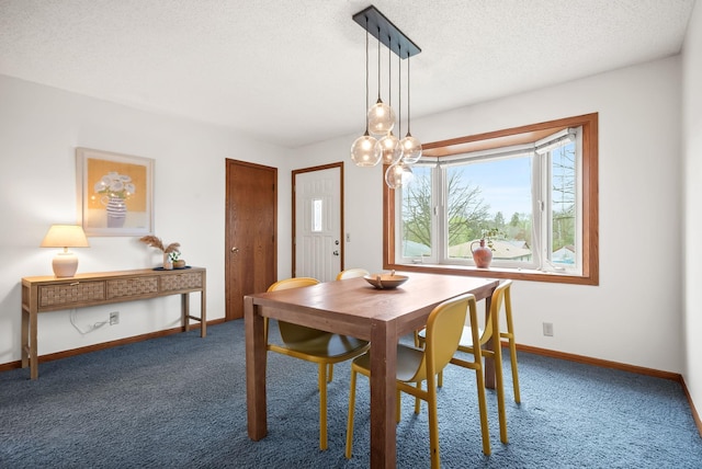 carpeted dining space with baseboards, a textured ceiling, and plenty of natural light