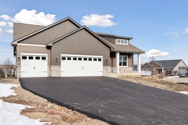 view of front facade with central AC unit and a garage