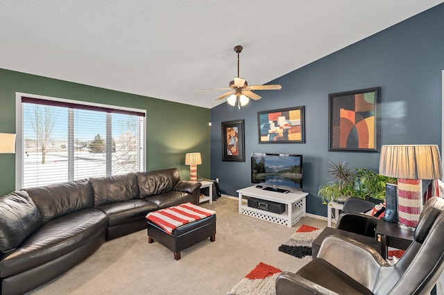 carpeted living room featuring vaulted ceiling and ceiling fan