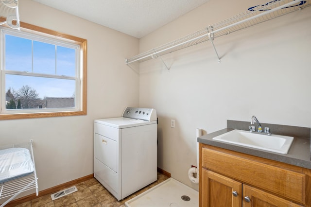 clothes washing area featuring cabinets, washer / clothes dryer, and sink