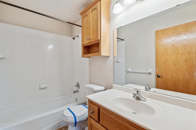 full bathroom featuring vanity, a textured ceiling,  shower combination, and toilet