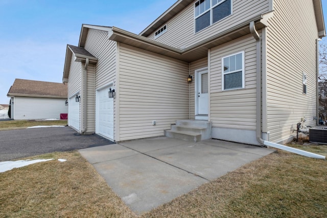 exterior space featuring a garage and central air condition unit