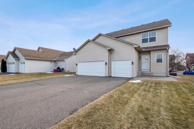 view of property with a front yard and a garage