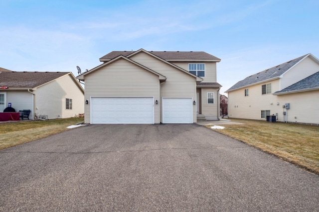 view of property with central AC, a front lawn, and a garage