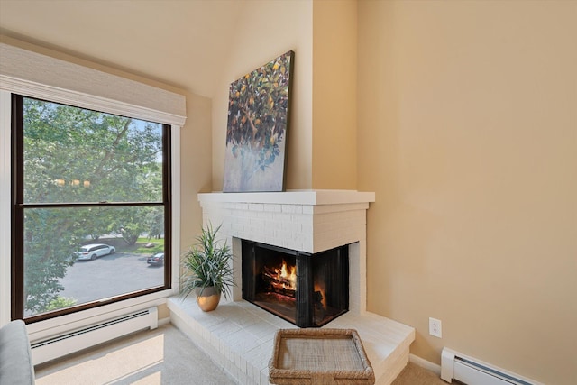 living room with baseboard heating and a brick fireplace