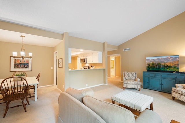 living room featuring light carpet, a chandelier, and lofted ceiling