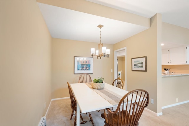 dining space featuring light carpet and an inviting chandelier