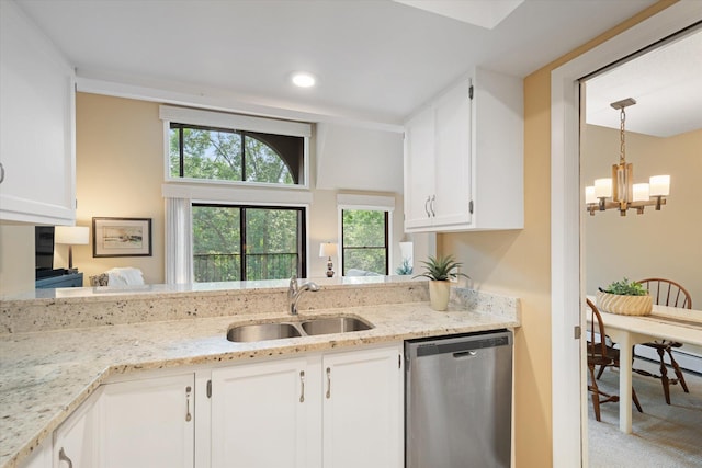 kitchen with light stone countertops, stainless steel dishwasher, sink, a notable chandelier, and white cabinets