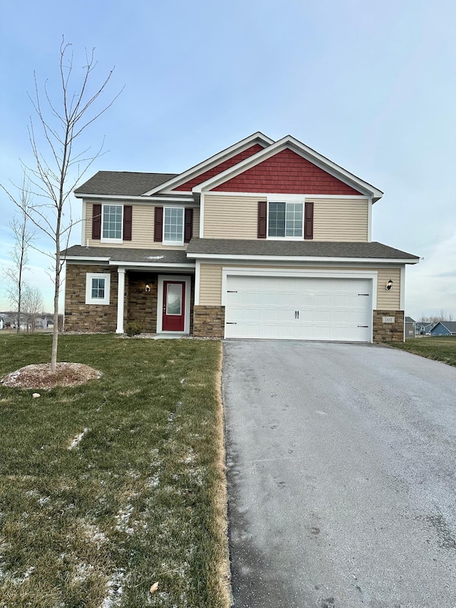 view of front of house with a garage and a front lawn