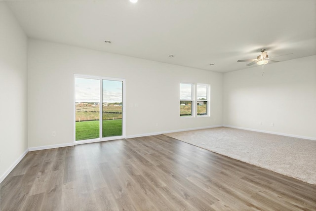 unfurnished room with ceiling fan and light wood-type flooring