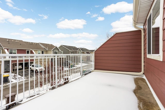 view of snow covered back of property