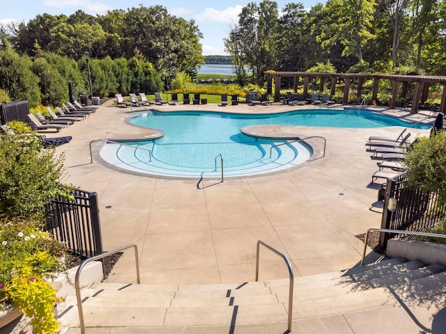 view of swimming pool with a water view and a patio