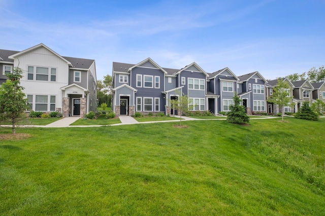 14592 Twin Lakes Cir, Burnsville, MN 55306 - multi unit property with stone siding, board and batten siding, a front yard, and a residential view