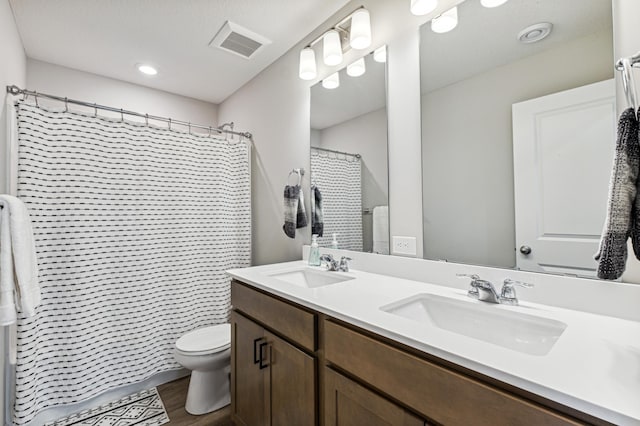 14592 Twin Lakes Cir, Burnsville, MN 55306 - full bathroom featuring wood finished floors, visible vents, toilet, and a sink