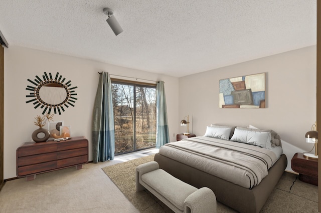 bedroom with light carpet and a textured ceiling