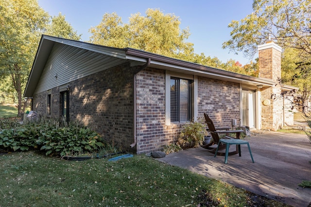 view of side of home with a patio