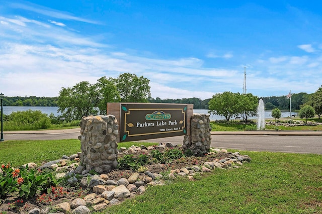 community / neighborhood sign with a water view