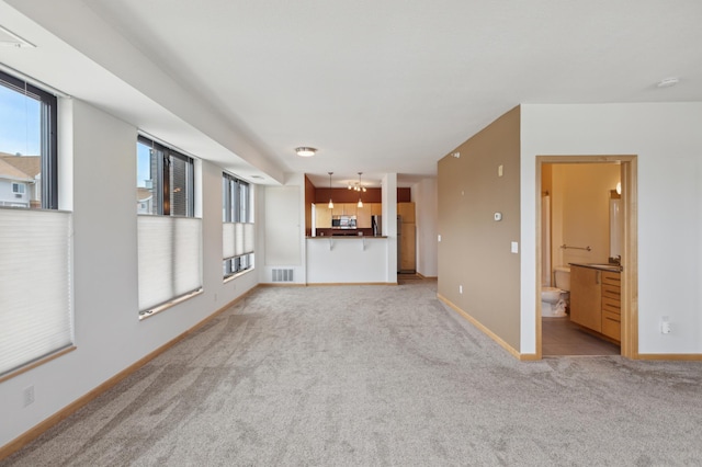 unfurnished living room featuring light carpet