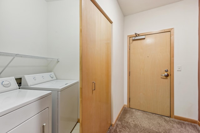 laundry area featuring light colored carpet and washing machine and clothes dryer