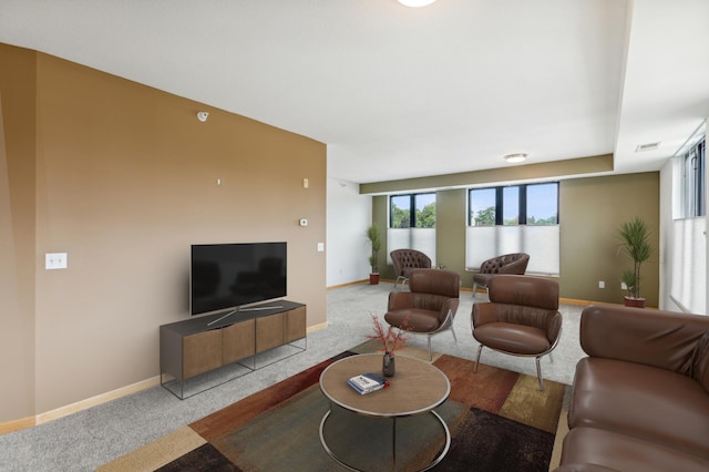 living room with carpet, visible vents, and baseboards