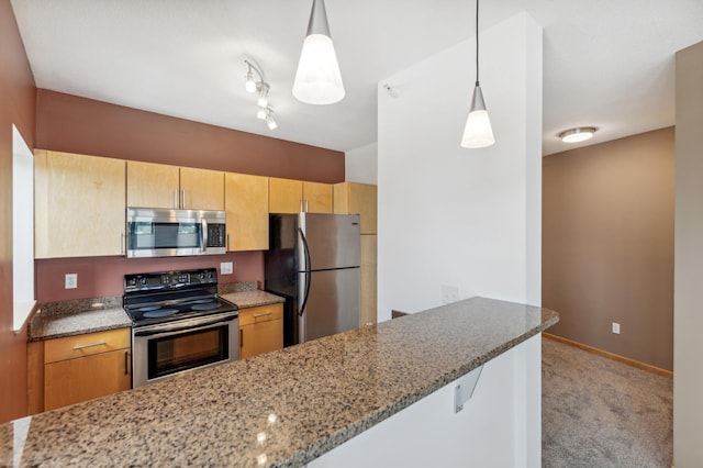 kitchen featuring pendant lighting, stainless steel appliances, light colored carpet, light stone countertops, and a peninsula