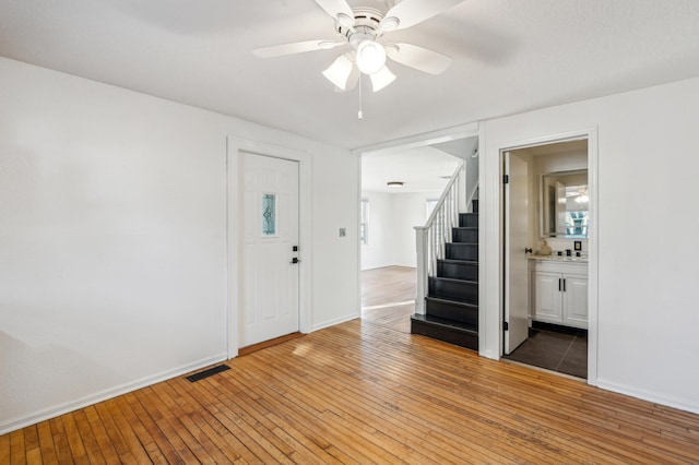 entryway with ceiling fan and wood-type flooring