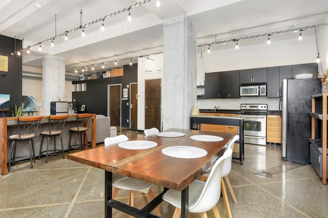 dining area featuring a high ceiling and decorative columns