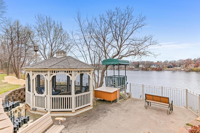 view of dock featuring a gazebo and a water view