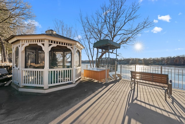 dock area with a gazebo and a water view