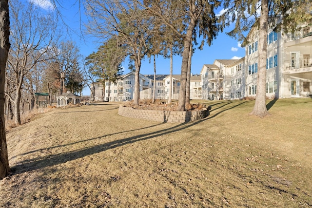 view of property's community featuring a gazebo and a lawn