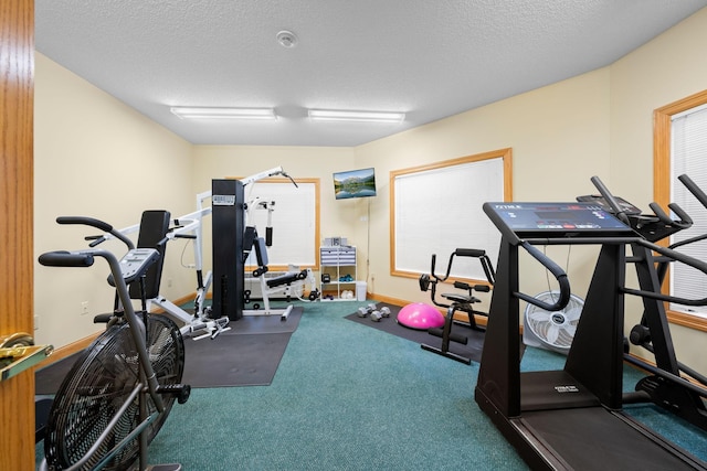 exercise area featuring a textured ceiling