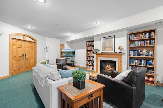 carpeted living room featuring a textured ceiling