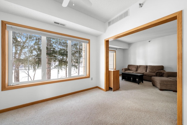 living room featuring light colored carpet and ceiling fan